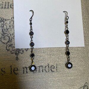 Long silver tone bezel set black stone dangle earrings